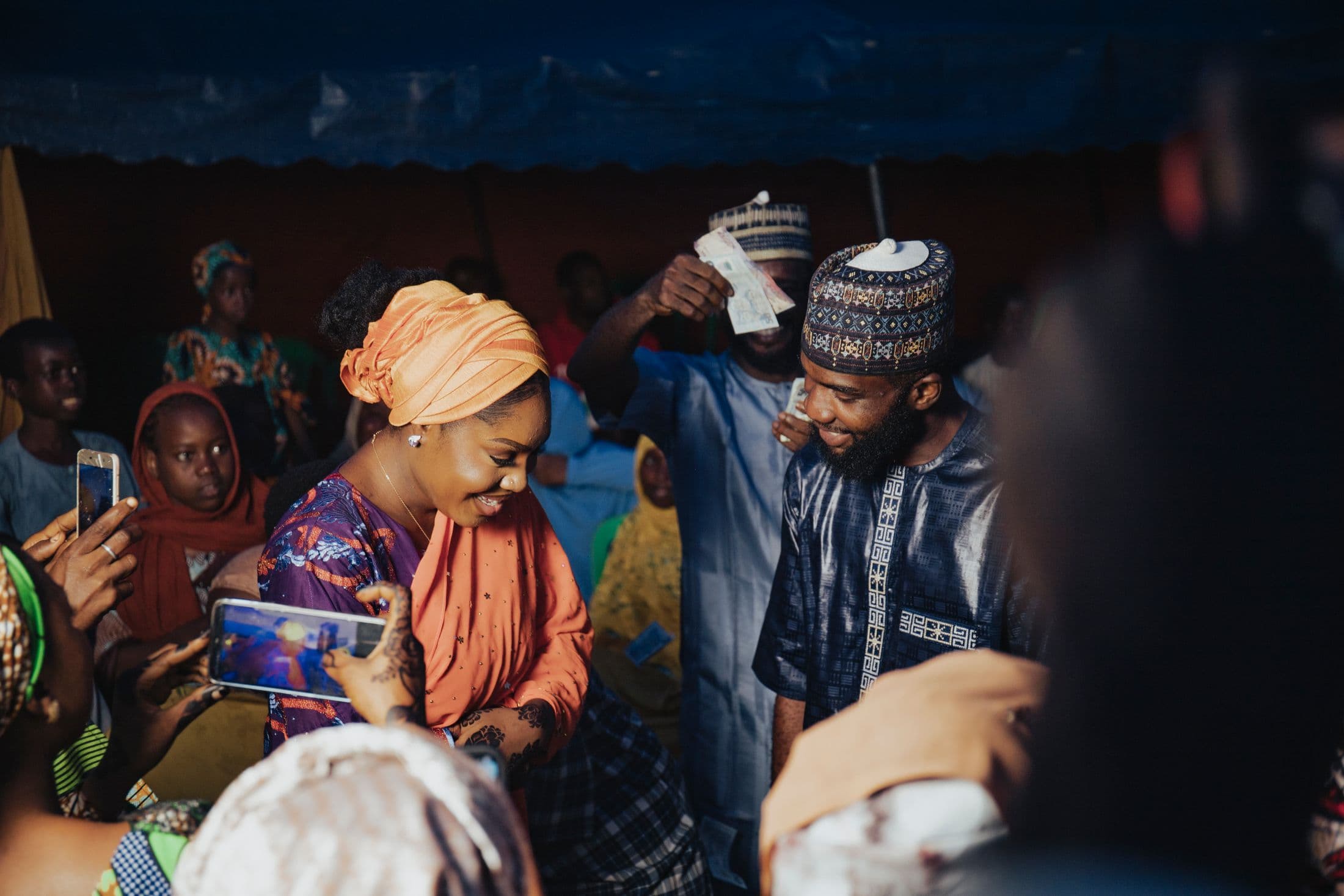 Friends celebrating and spraying money at a Nigerian party