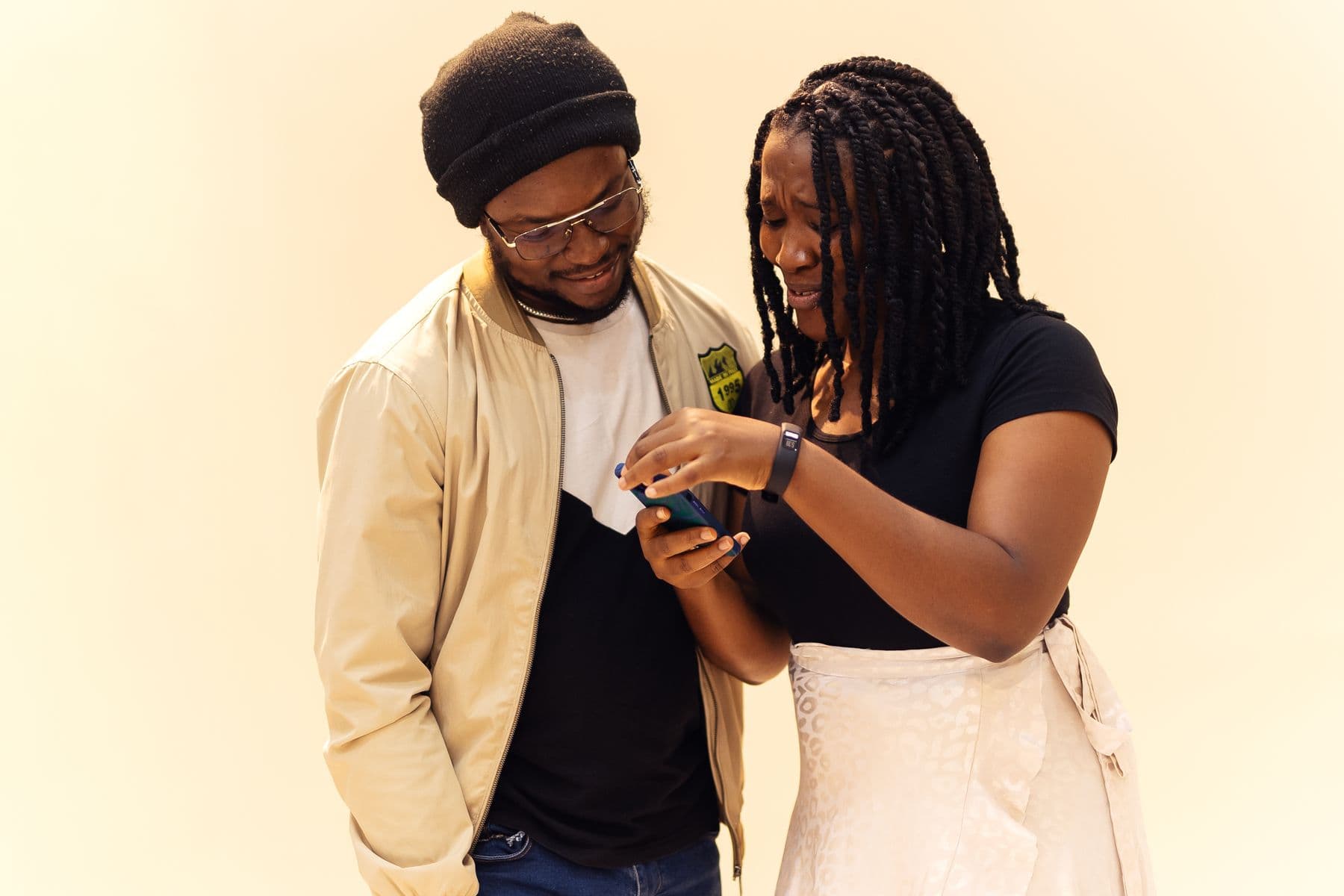 Two friends looking at a phone together